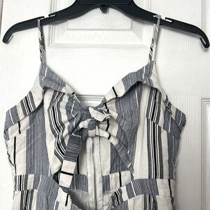 Striped jumpsuit with cutout in the the front. Zipper in the back.